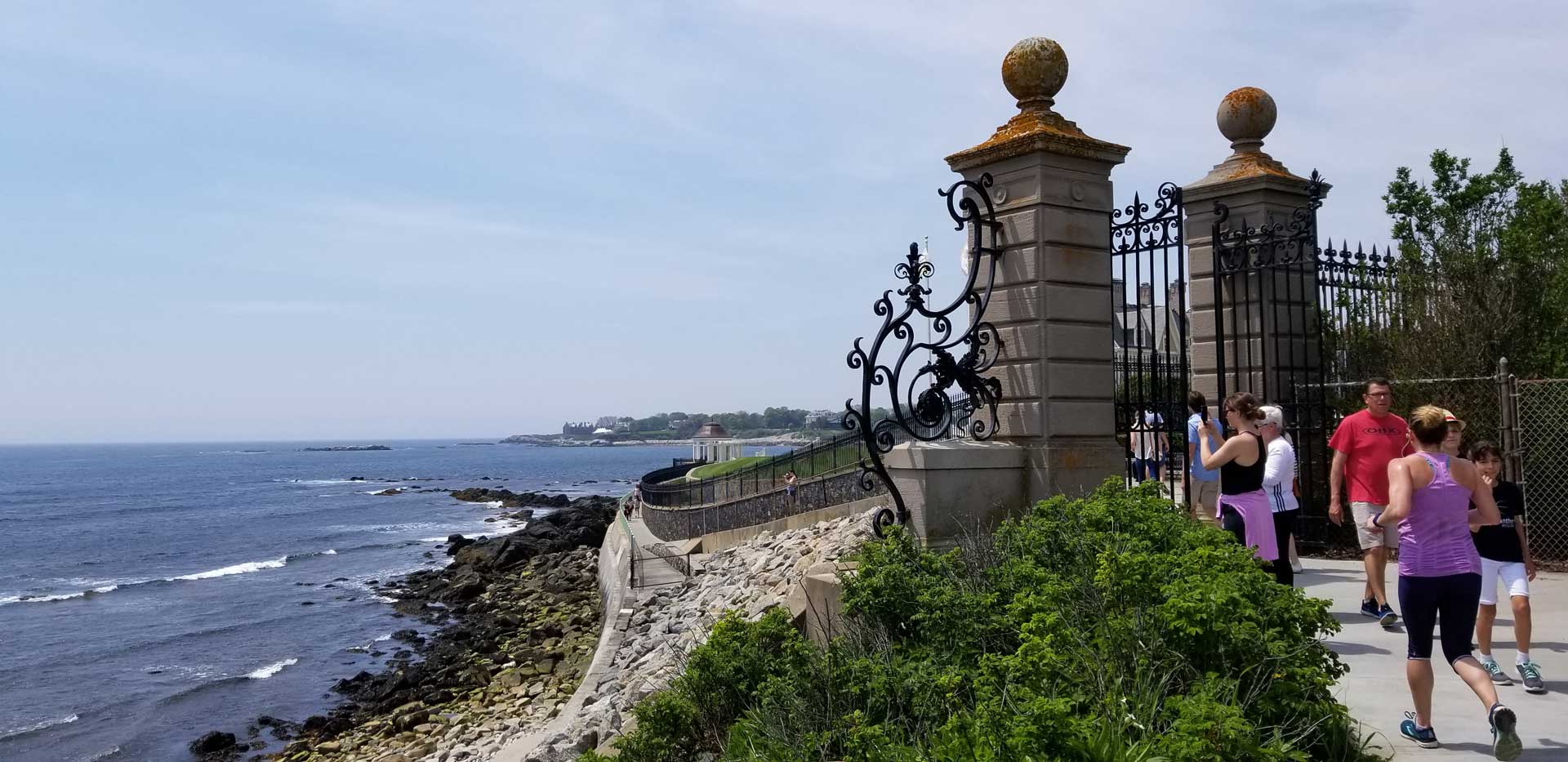 Group of tourists entering the The Cliff Walk entrance - an experience included in the Cliff Walk Tour.