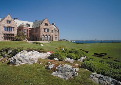 View of the Rough Point Mansion surrounded with green grass fields.