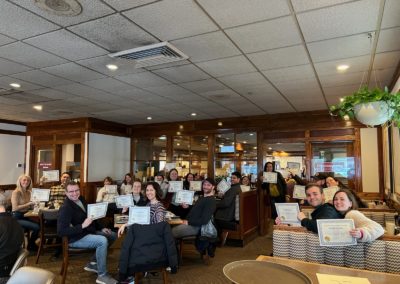 Tourists holding their certificate of attendance to the tour provided facilitated by Experience Rhode Island Tours.