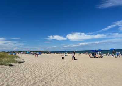 Tourist roaming the Mohegan Bluffs Beach - a destination included in the Beautiful Block Island Tour.