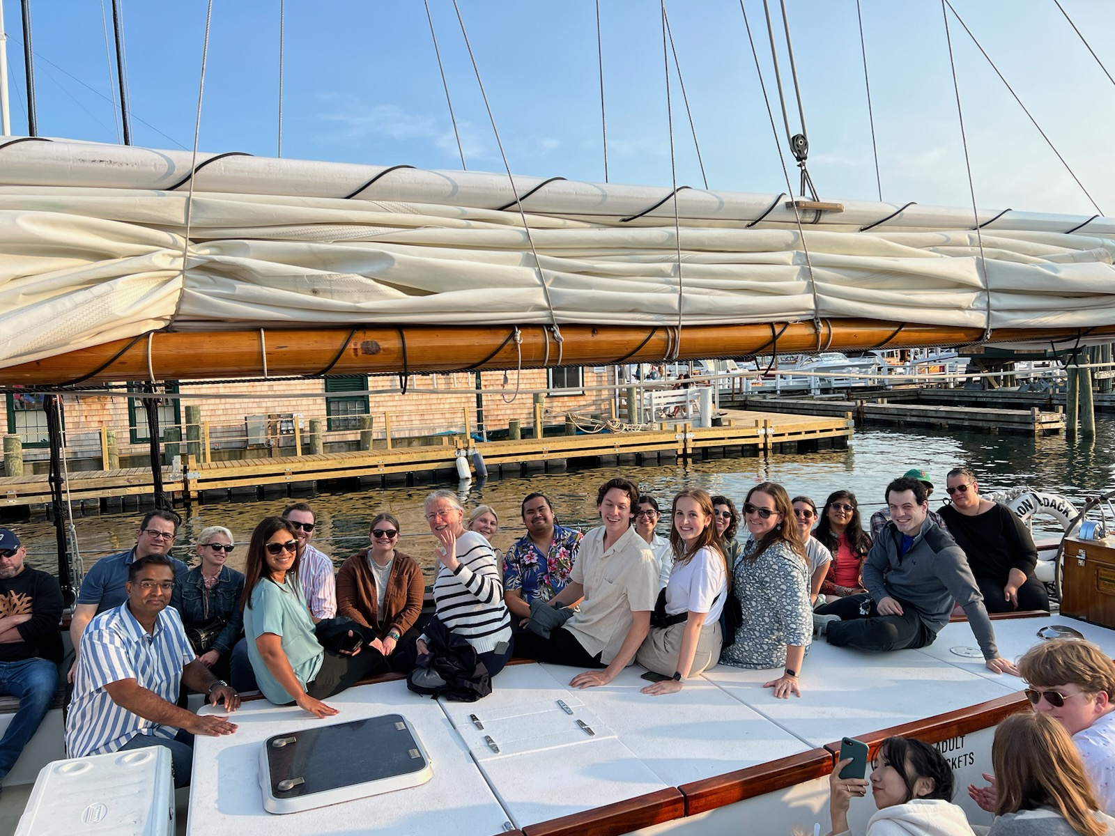 Group of people on board an elegant schooner cruising the Narragansett Bay.