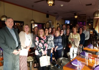 Group picture of tourist at a famous restaurant in Providence, RI - an activity included in the Dine Around Providence Tour.