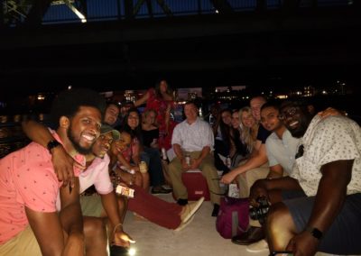 Group of tourist enjoying an evening cruise by the Providence River - an activity included in the Dinner and a Cruise Tour