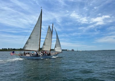 Gourp of tourists onboard a Newport Classic Cruise sailing - an activity part of the Newport Sail Tour.