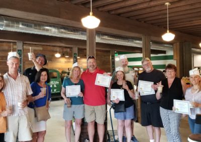 Group picture of tourist holding their certificate of completing the Taste of Rhode Island Tour.