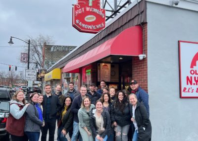 Group picture of tourists at the M&M New York System - a destination included in the Taste of Rhode Island Tour.