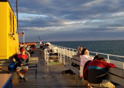 Tourist sitting on the deck of the ferry bound for Block Island - a destination included in the Beautiful Block Island Tour.