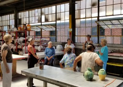 Group of elderly tourists listening to the tour guide about the story of the building there in.