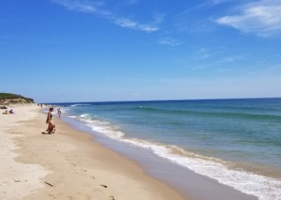 Tourists with their babies playing at the Baby Beach - a destination included in the one of the Beautiful Block Island Tour.